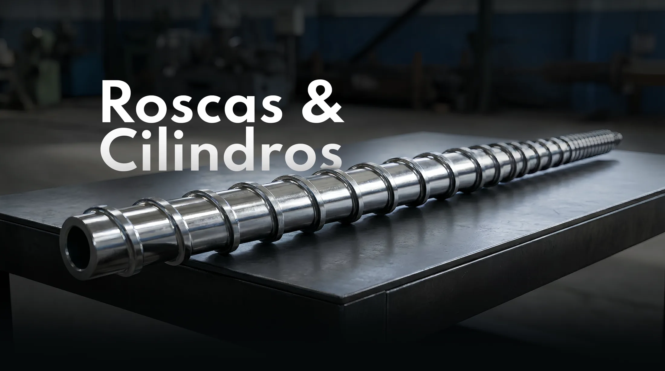 Rosca e cilindro de aço polido sobre bancada industrial, com o título Roscas e Cilindros
